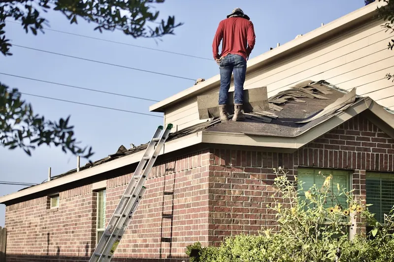 Professional roofer working on a residential roof in Hickam Housing